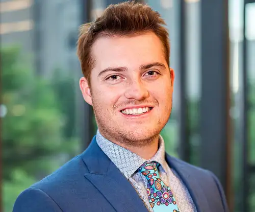 A smiling man in a blue suit
