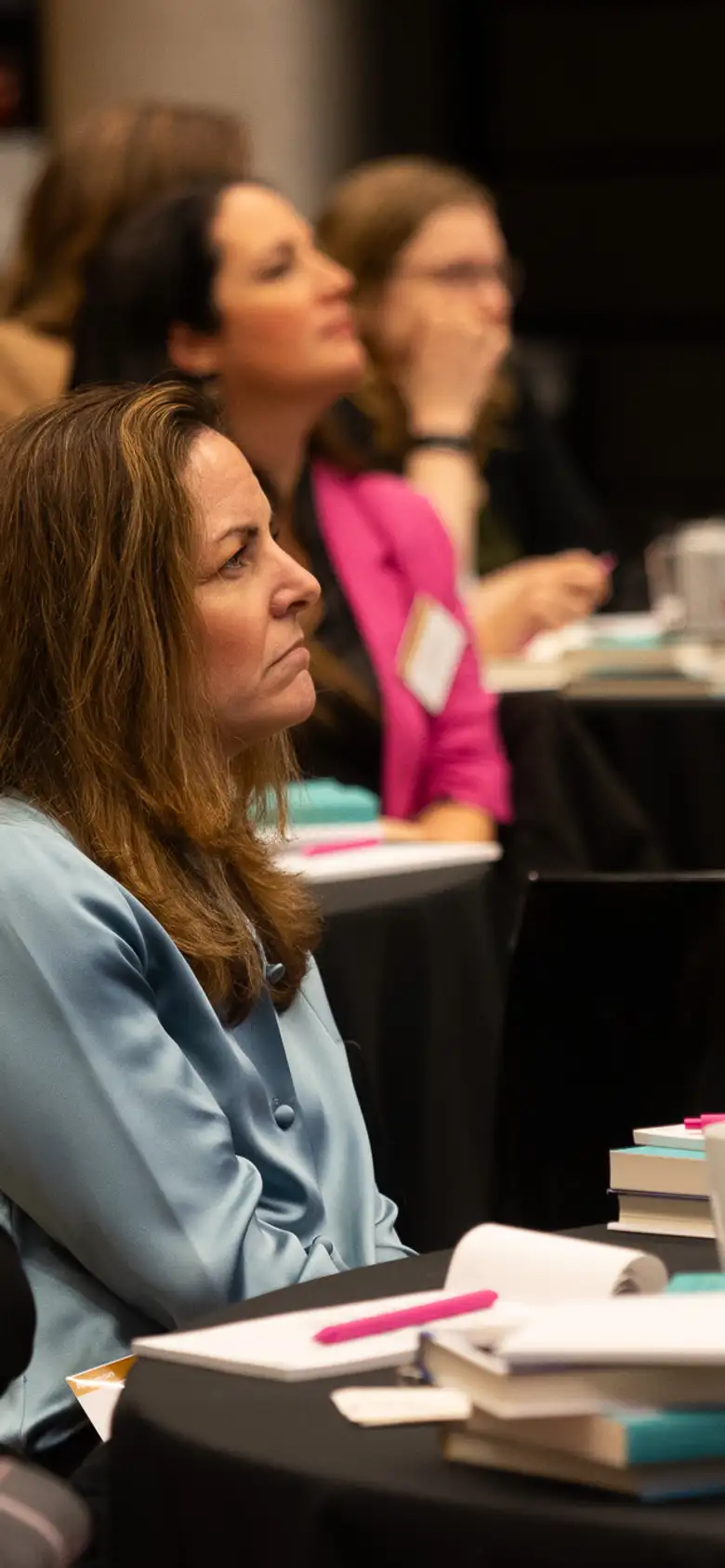 Women at table listening to speaker