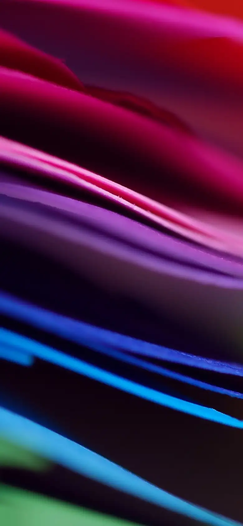 wavy lines in a colourful rainbow resembles a close up of a pile of paper folders