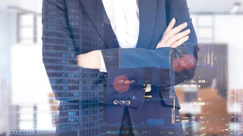 Image a torso in a suit with two hands crossed