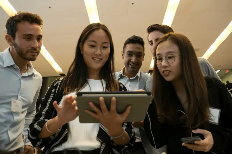 A group looks at a table.